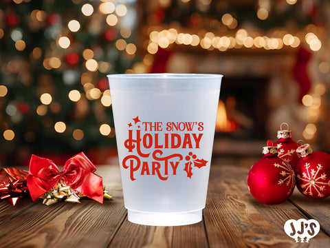 A close-up of a frosted glass cup with a Christmas tree design.