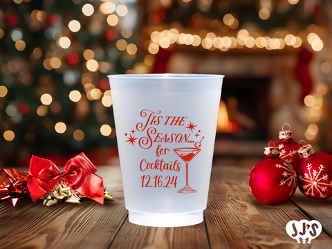 A close-up of a frosted plastic cup with a Christmas tree design and a personalized name.