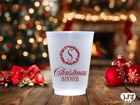 A frosted Christmas monogram wreath cup, customizable with your initial and color choice. Perfect for adding a personalized touch to your holiday celebrations.