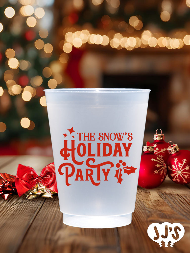 A close-up of a frosted glass cup with a Christmas tree design.