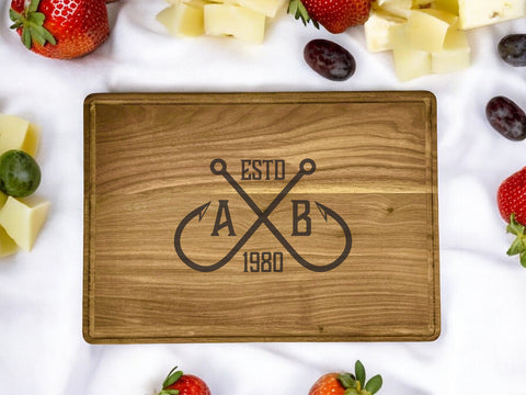 A personalized walnut cutting board with a crossing hooks design, featuring a custom name or message.