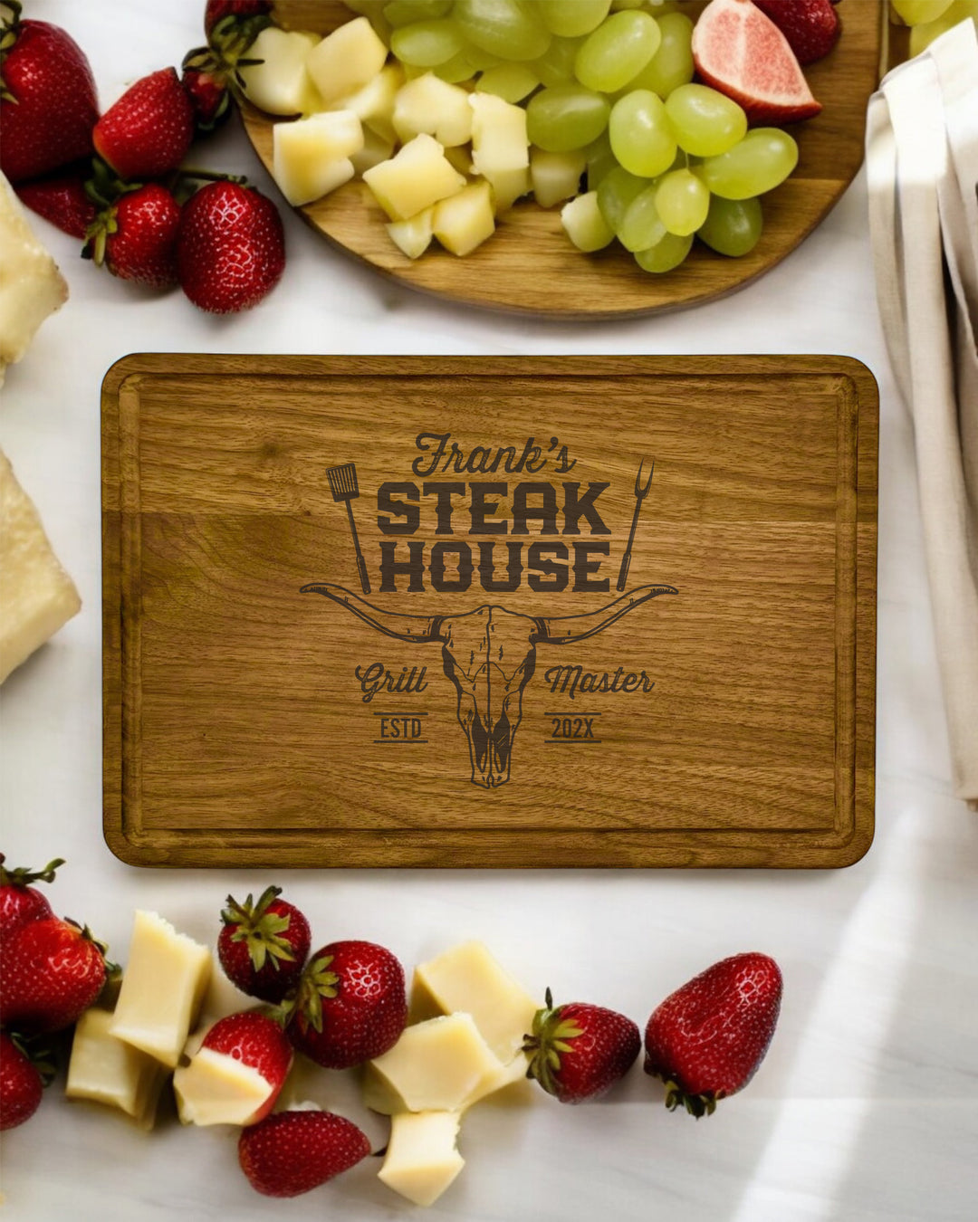 A personalized walnut cutting board with engraved text and a custom design.