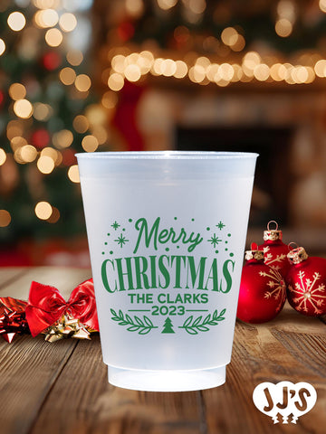 A frosted plastic cup with a classic Christmas design, personalized with custom text.