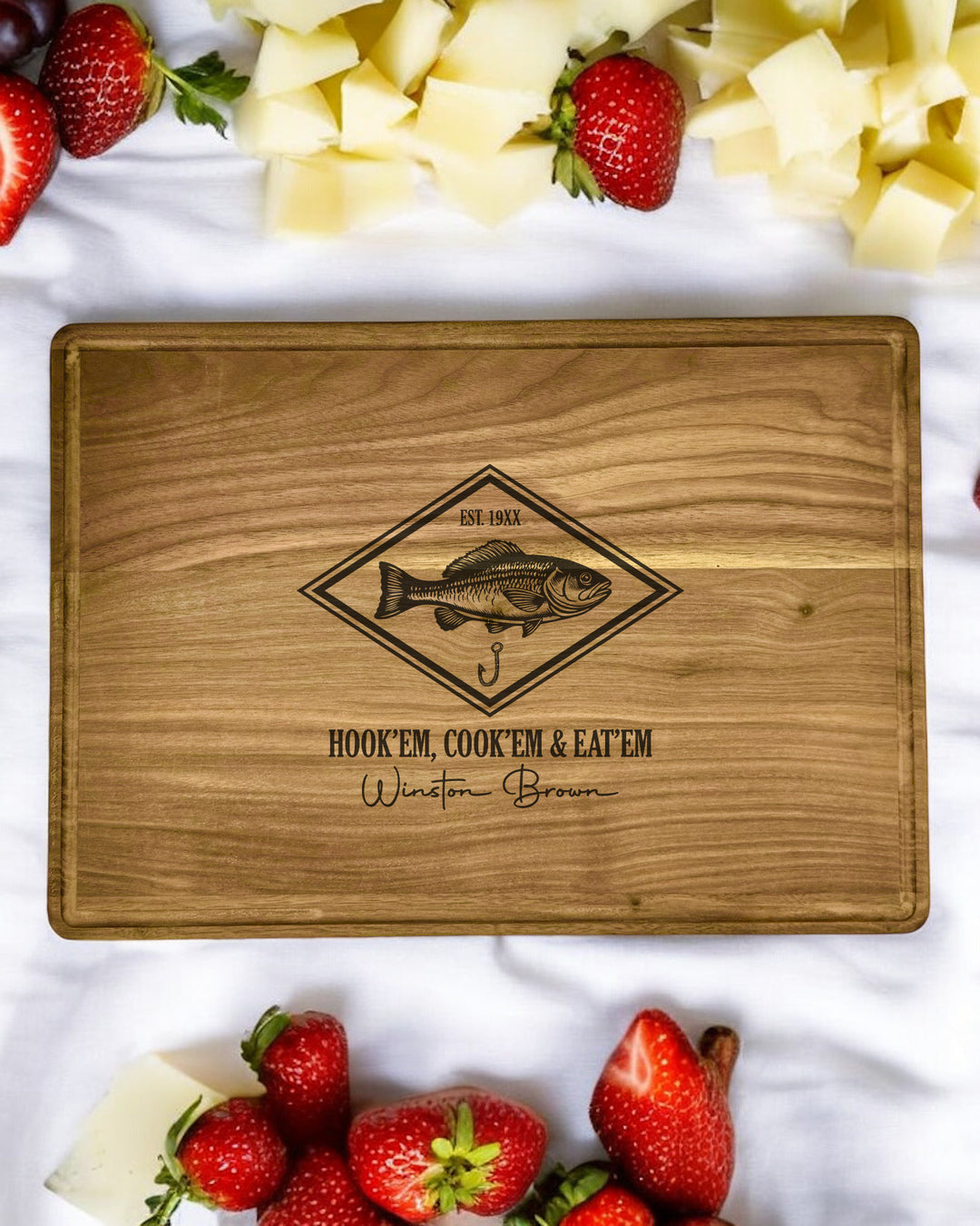 A personalized walnut cutting board with a fishing-themed saying, featuring rich grain patterns and warm tones.