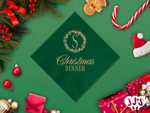 A table setting featuring the Christmas Monogram Wreath Custom Christmas Napkins, paired with other festive holiday decor.