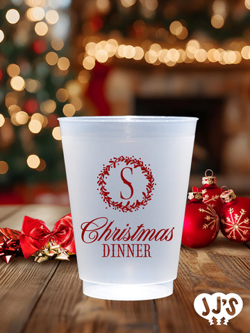 A frosted Christmas monogram wreath cup, customizable with your initial and color choice. Perfect for adding a personalized touch to your holiday celebrations.