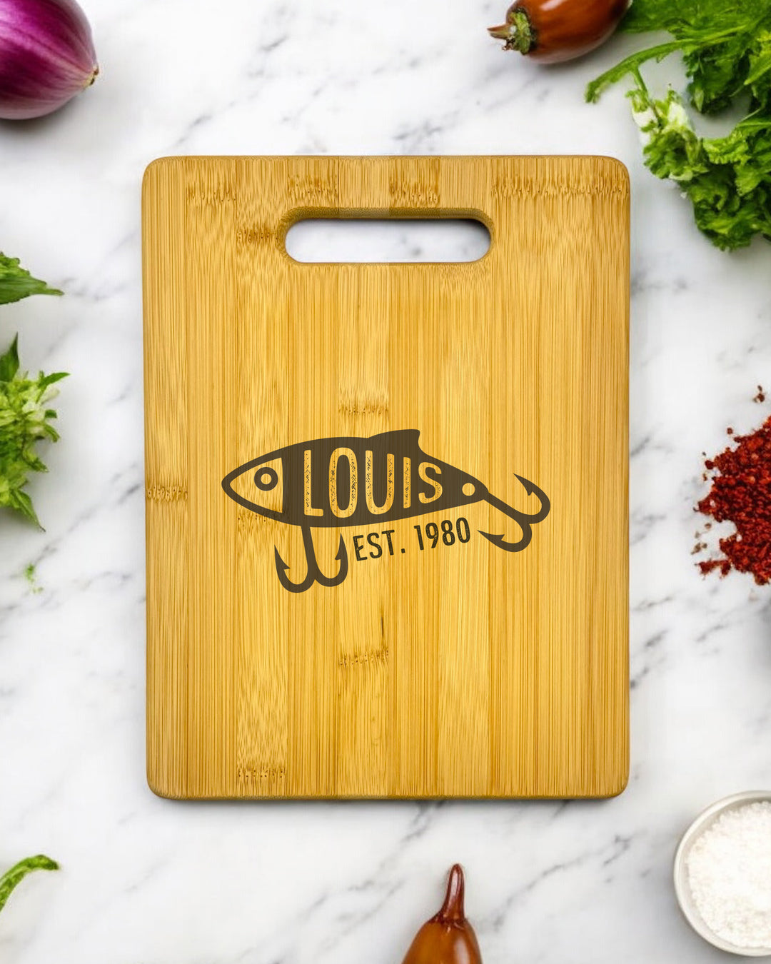 A personalized bamboo cutting board with a fishing lure design. The board can be customized with a name or message.