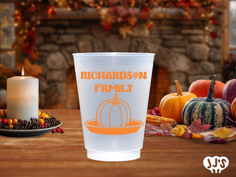 A close-up image of a custom frosted cup with a pumpkin pie design and personalized text.