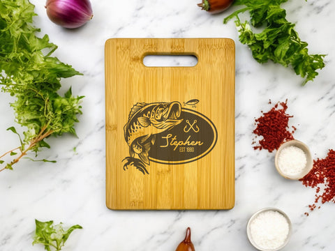 Personalized bamboo cutting board with engraved fishing scene, customizable with name, date, and message.